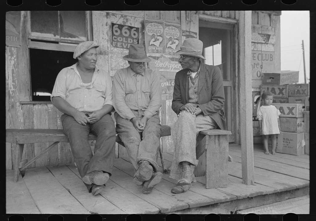 [Untitled photo, possibly related to: Negroes talking on porch of small store near Jeanerette, Louisiana]