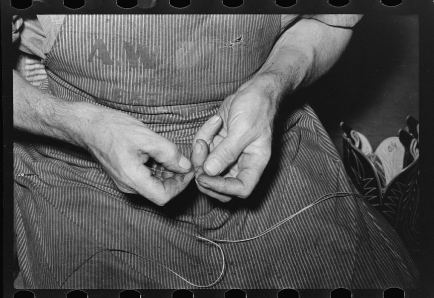 Lee, Russell, photographer. Threading a needle with waxed thread. Bootmaking shop, Alpine, Texas. May, 1939. Image. Retrieved from the Library of Congress, https://www.loc.gov/item/fsa1997026143/PP/. (Accessed September 19, 2016.)
